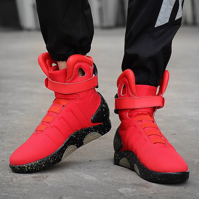 Red high-top sneakers with black soles on a gray pavement background