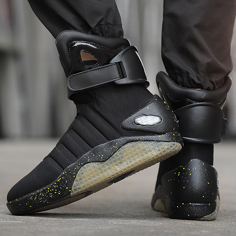 Black high-top sneakers with a futuristic design on a neutral background