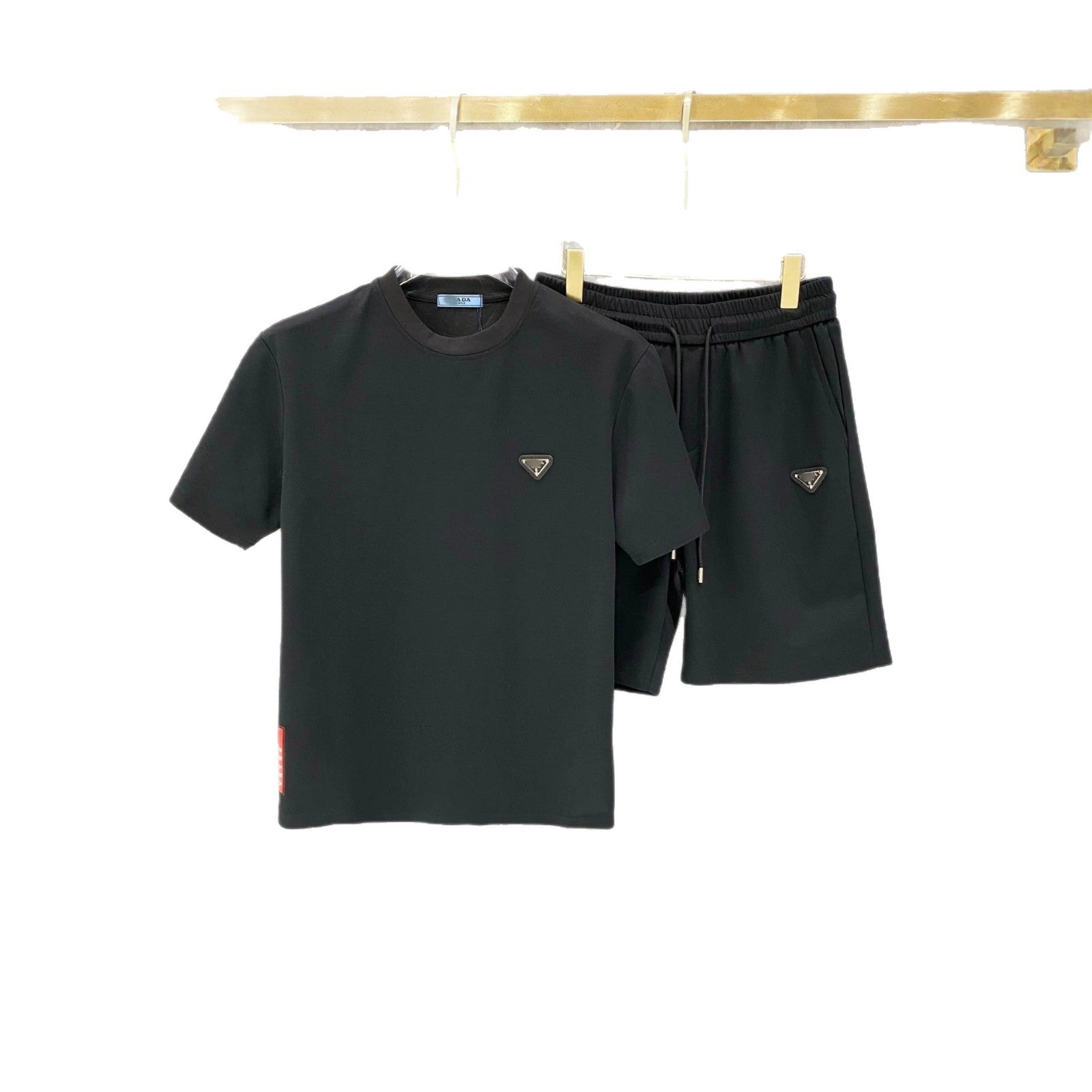 Black t-shirt and shorts set with brand logo on a white background