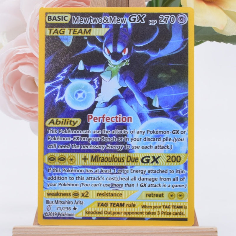 A Pokémon GX trading card featuring Mewtwo and Mew, displayed upright on a small wooden stand against a soft pink floral background.
