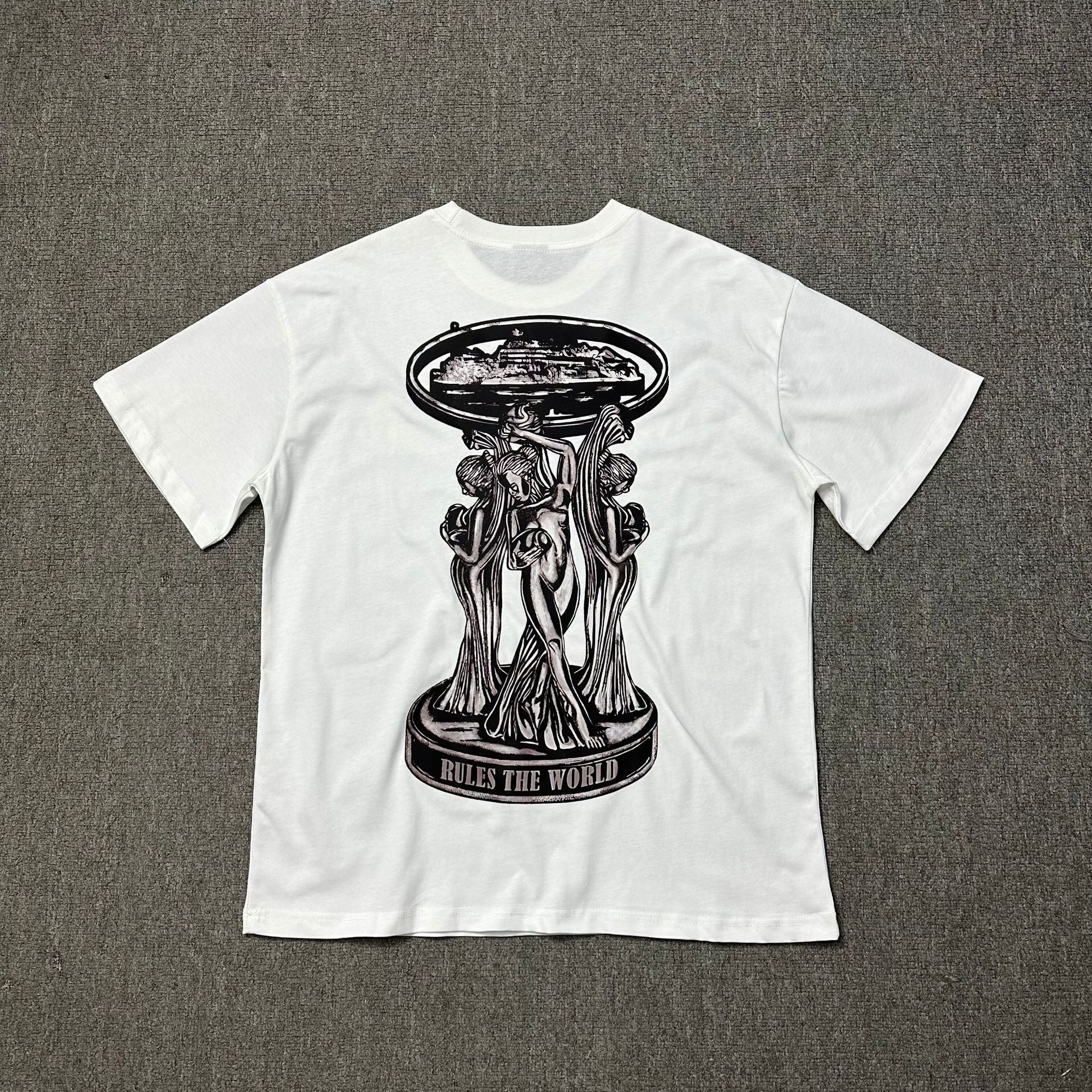 White t-shirt with black graphic design on a gray background