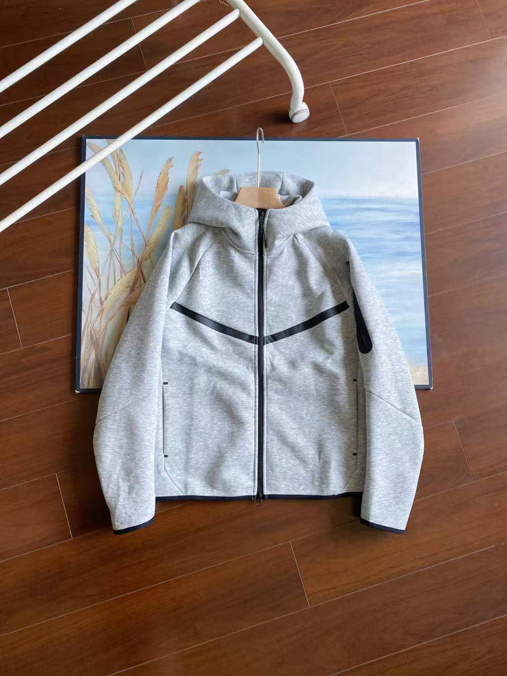 Gray jacket with black accents on a wooden floor