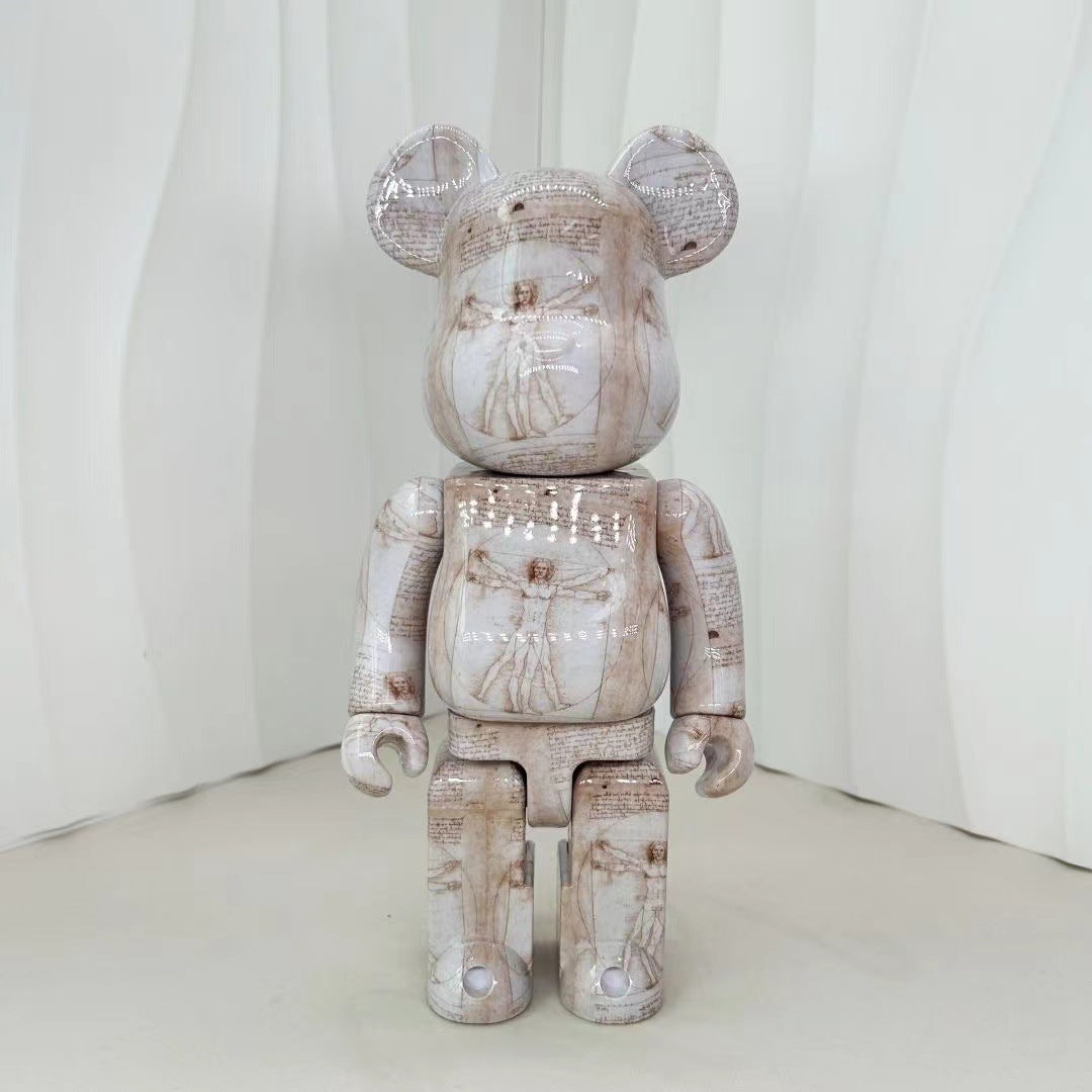 A collectible bear-shaped figurine with a distressed, textured print featuring Leonardo da Vinci's 'The Sistine Chapel' paintings and Michelangelo's 'David' on its surface, standing against a white draped background.