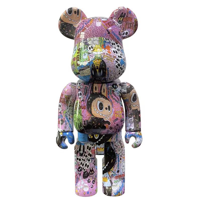 A collectible bear-shaped figure covered in colorful graffiti-style artwork, shown against a plain white background.