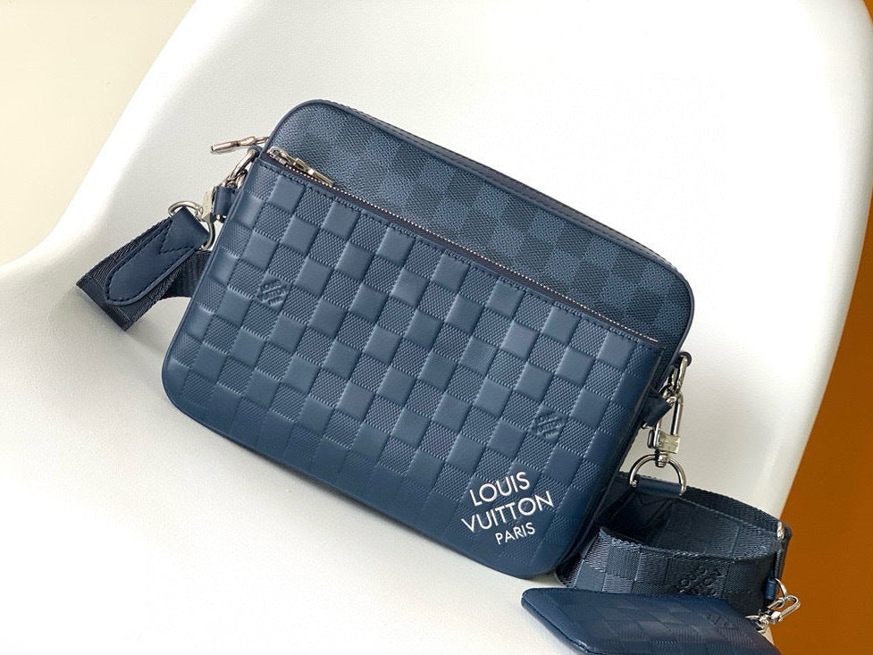 Blue woven handbag with Louis Vuitton logo on a white chair
