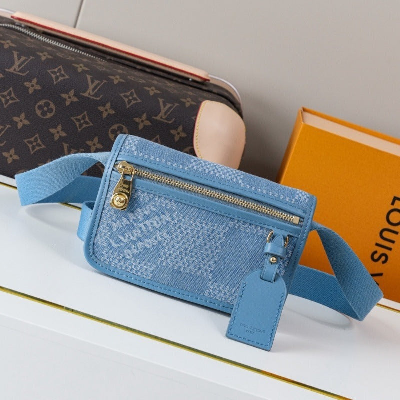 A Louis Vuitton monogram canvas crossbody bag in light blue with gold-tone hardware, displayed on a white surface with a Louis Vuitton box in the background.