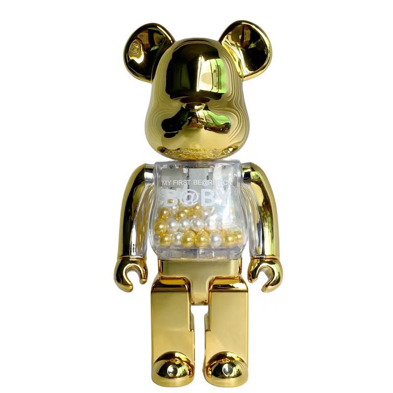 A metallic gold bear-shaped collectible figure with a transparent chest filled with small gold and white pearls, shown against a plain white background.