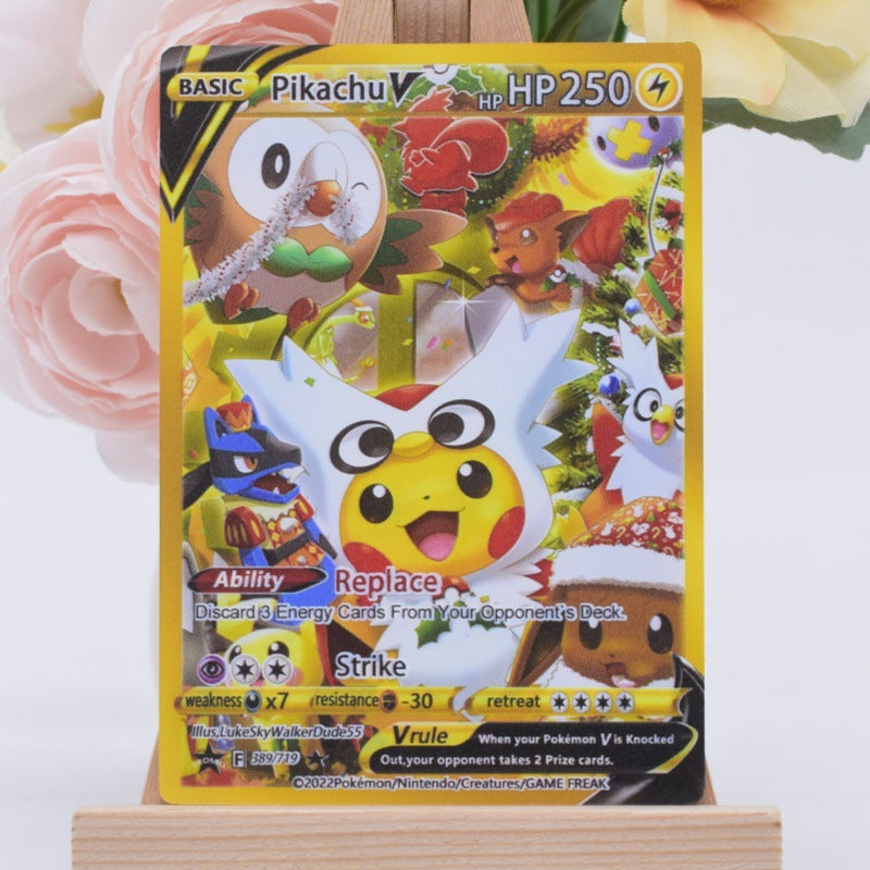 A Pokémon trading card featuring Pikinu, displayed upright on a small wooden stand with soft pink flowers blurred in the background.