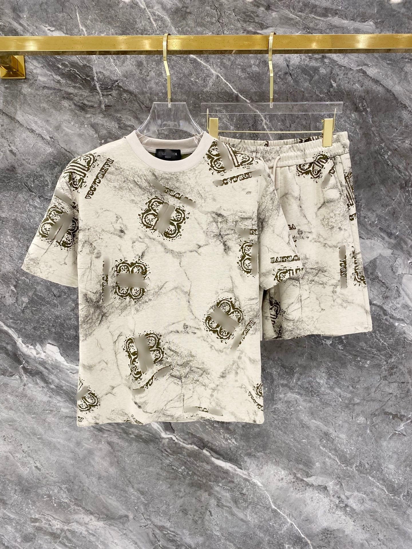 Fashionable outfit with a patterned shirt and shorts on a marble background