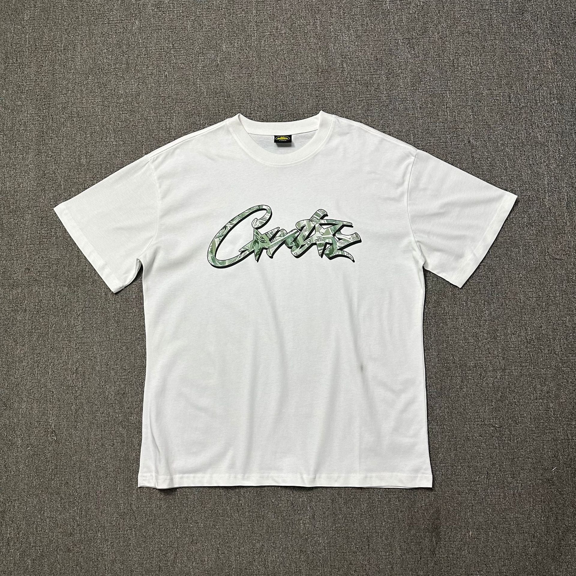 White t-shirt with green text on a gray background