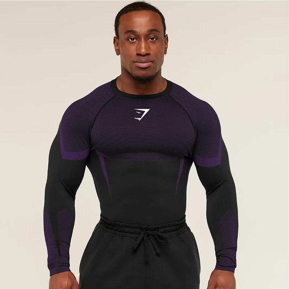 Man wearing a black and purple athletic outfit with a logo on a beige background
