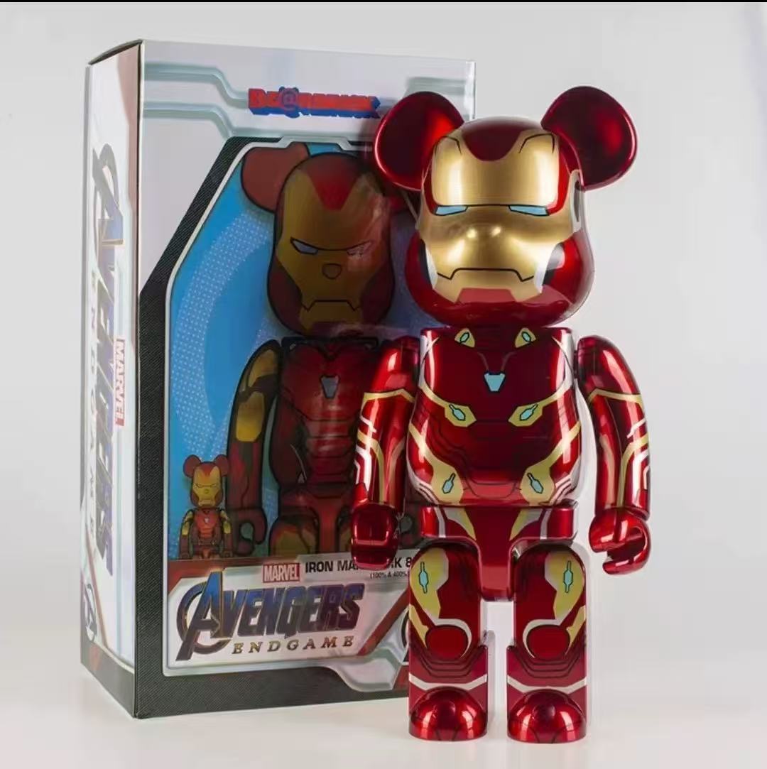 Iron Man Max 12000 Beast Mode collectible figure standing next to its original packaging box. The figure has a metallic red and gold finish with blue eyes and small green accents.