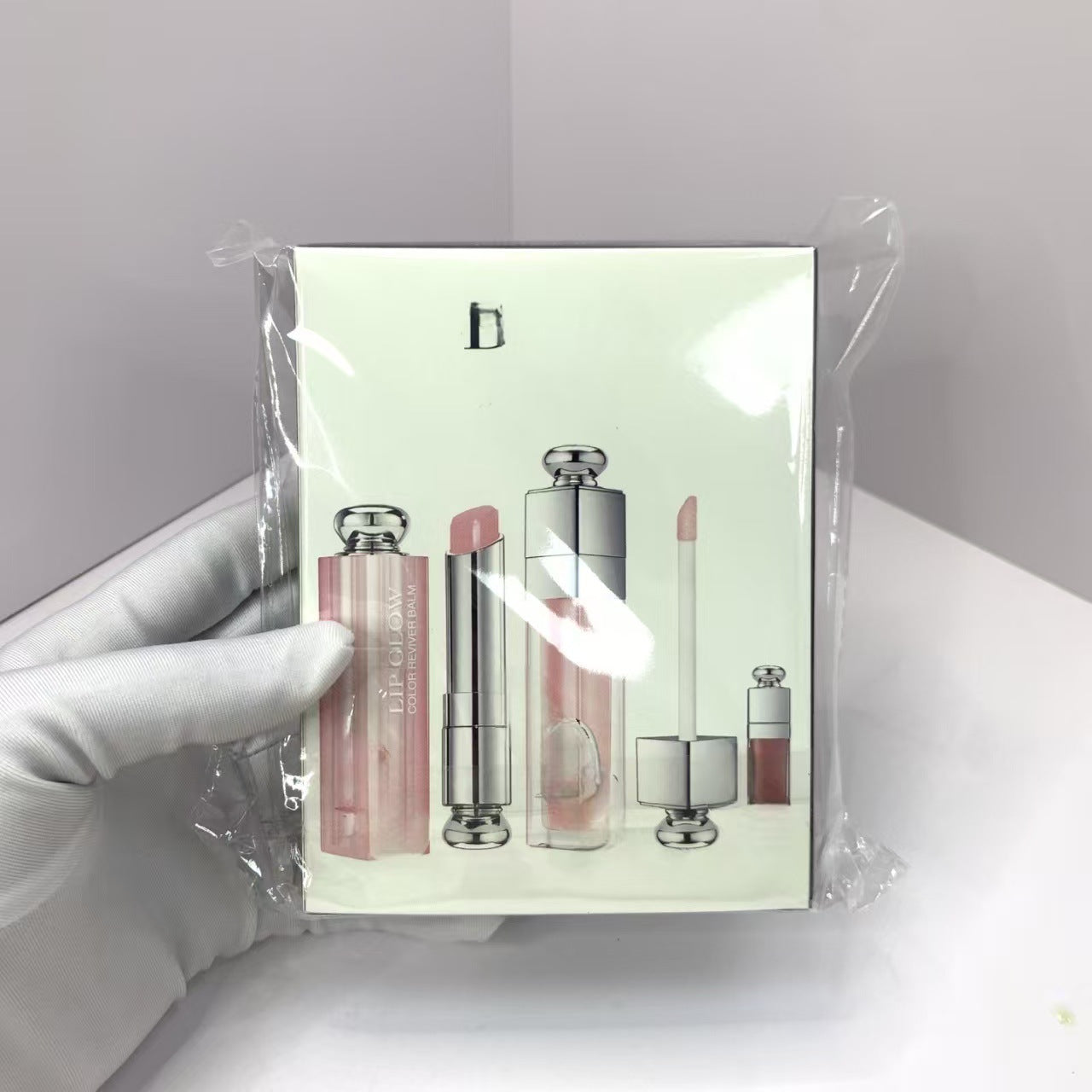 Set of lip products in a clear plastic packaging with a white background
