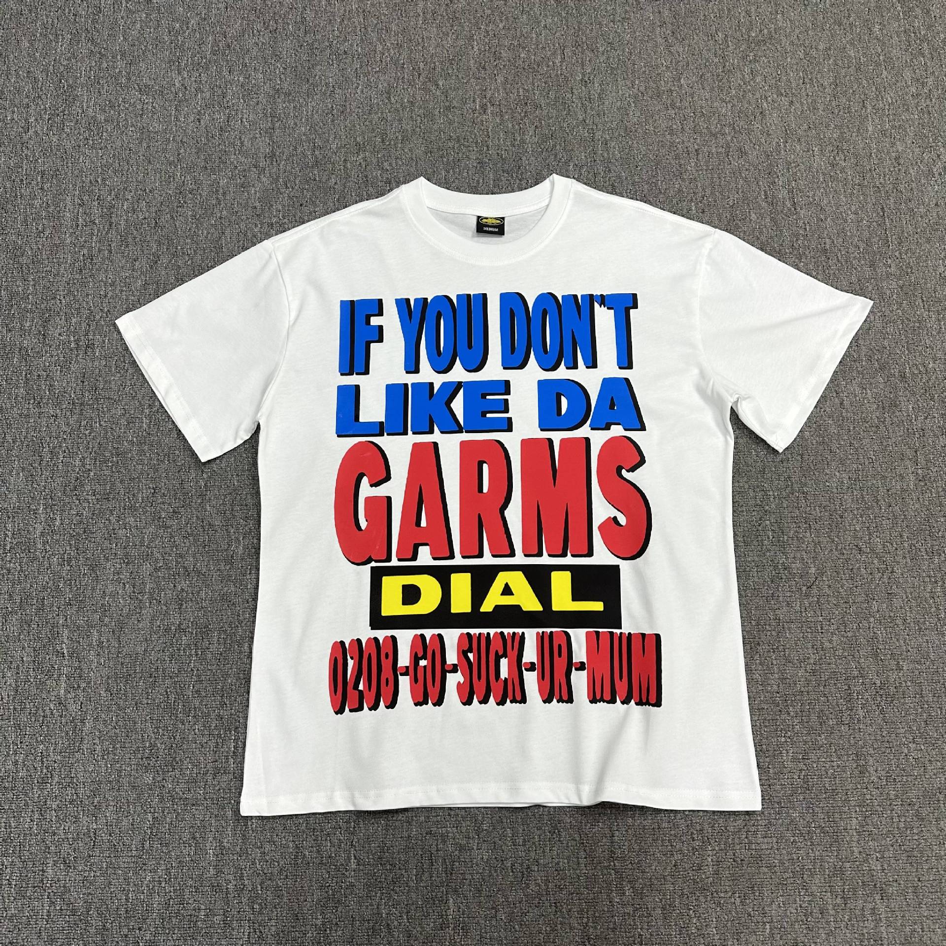 White t-shirt with colorful text on a gray background