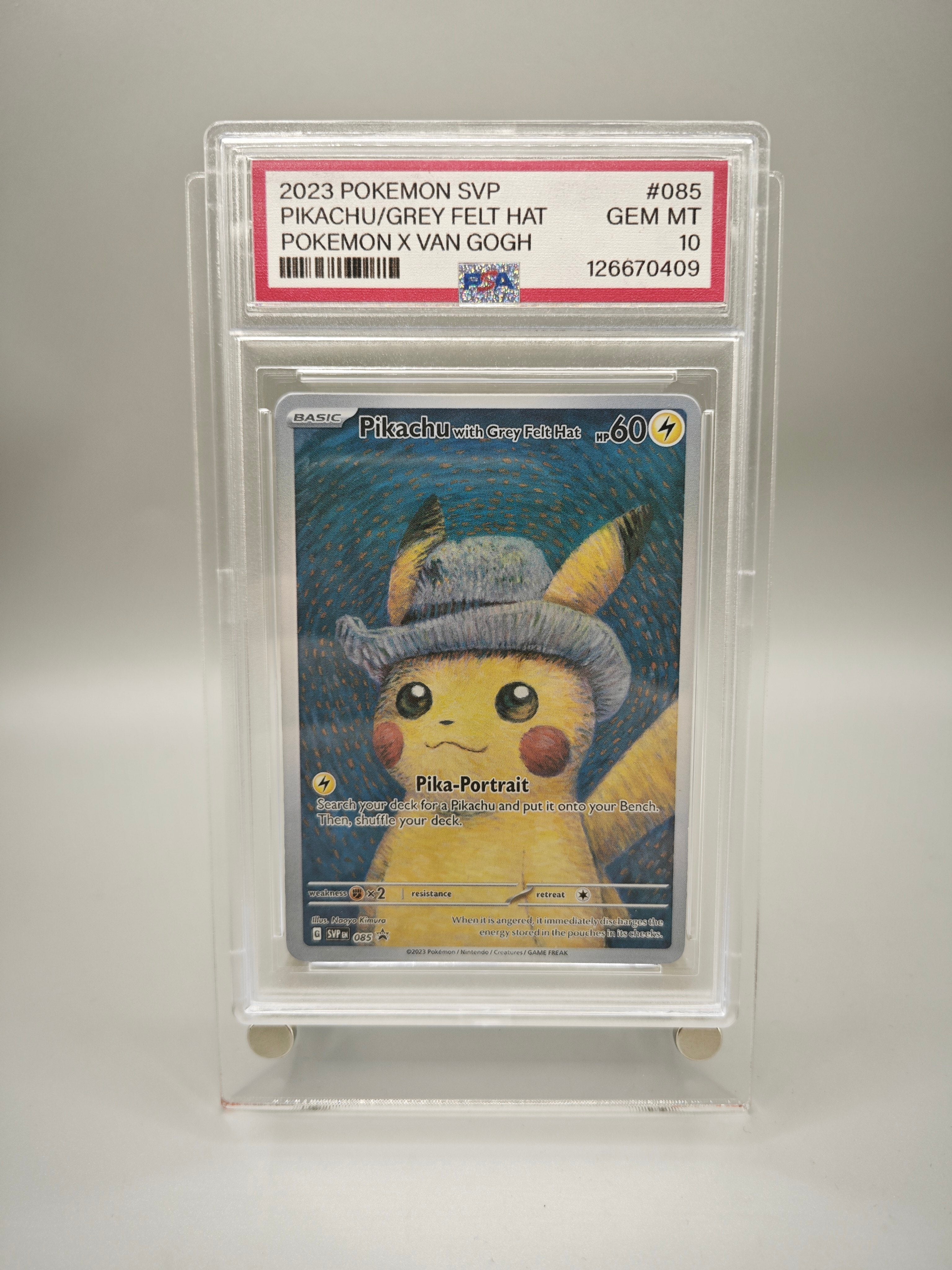 A graded Pokémon card featuring Pikachu in a grey felt hat, sealed in a clear PSA-style holder with a red label at the top. The card is photographed against a plain light gray background.