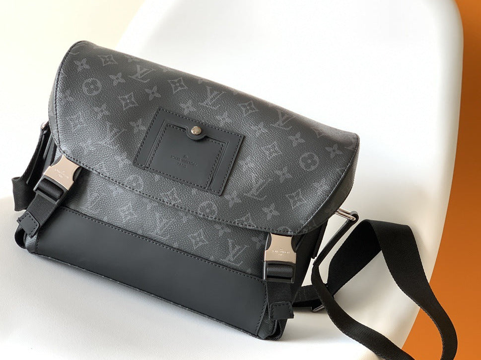 Gray leather bag with monogram pattern on a white surface