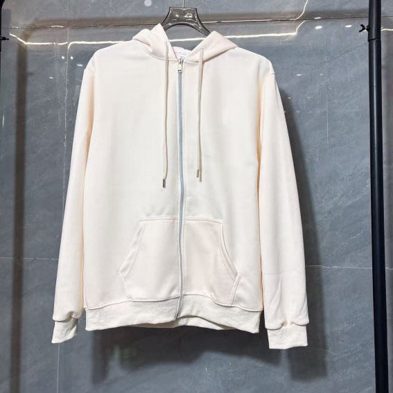 White hoodie on a black rack against a gray wall
