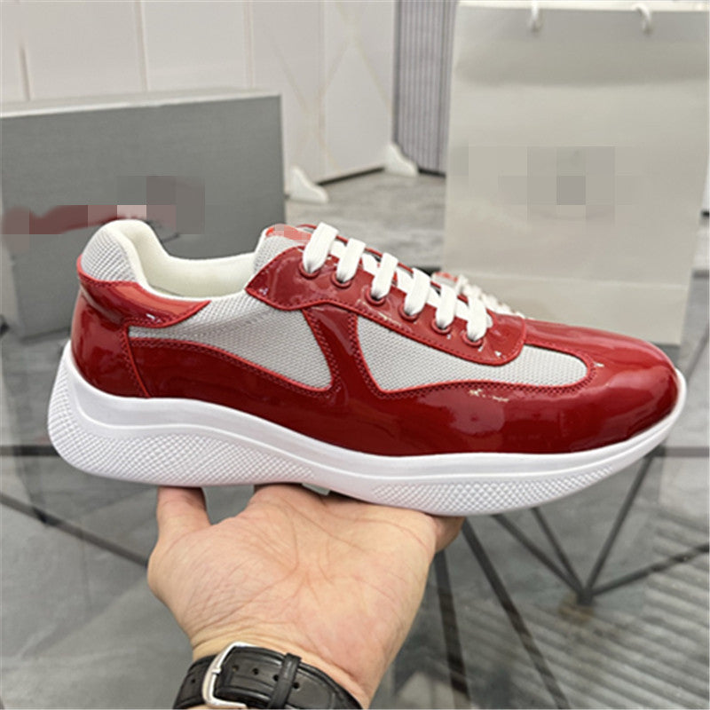 Red and white sneaker held in a hand with a blurred background