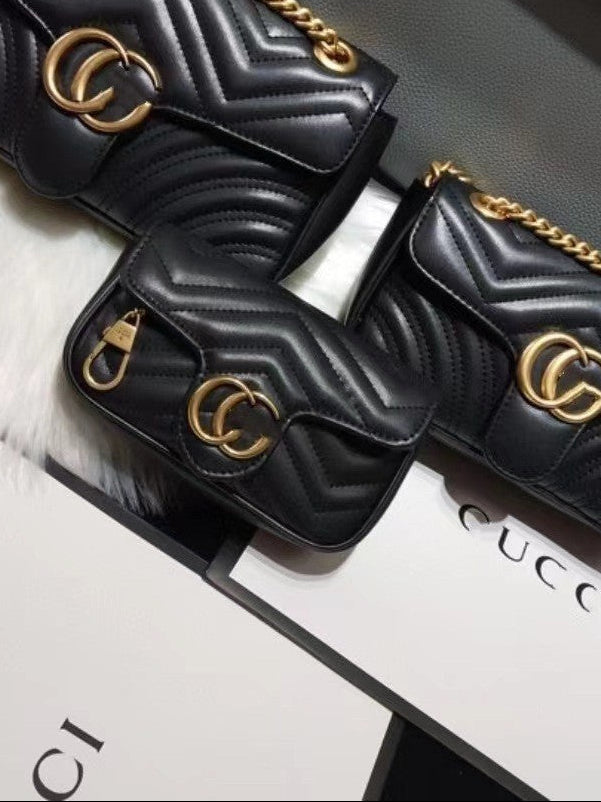 Three black quilted leather shoulder bags with gold chain straps and interlocking GG logo hardware, displayed with Gucci