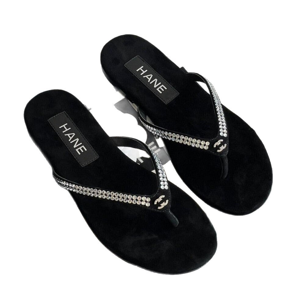 Black sandals with rhinestone straps on a white background