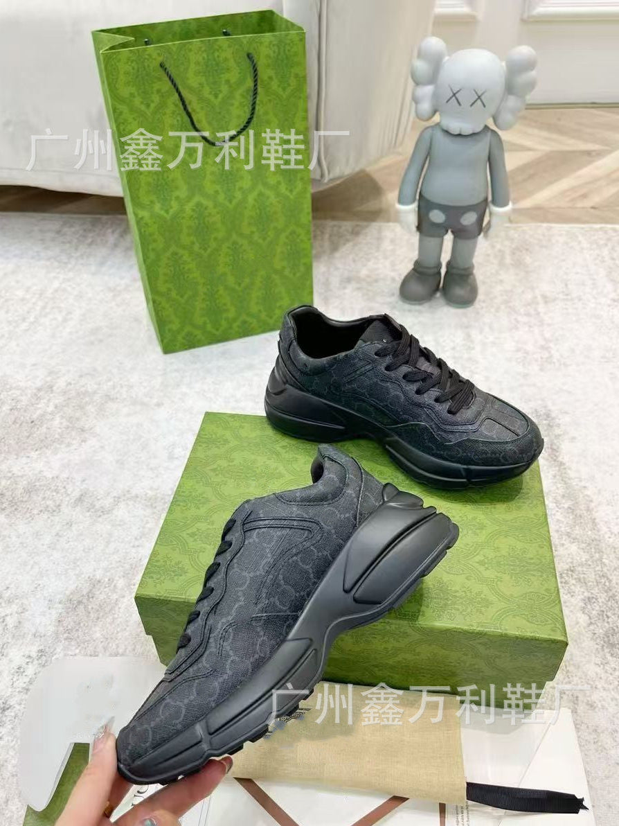 Black sneakers on a Gucci box with a green Gucci bag and KAWS figure in the background.