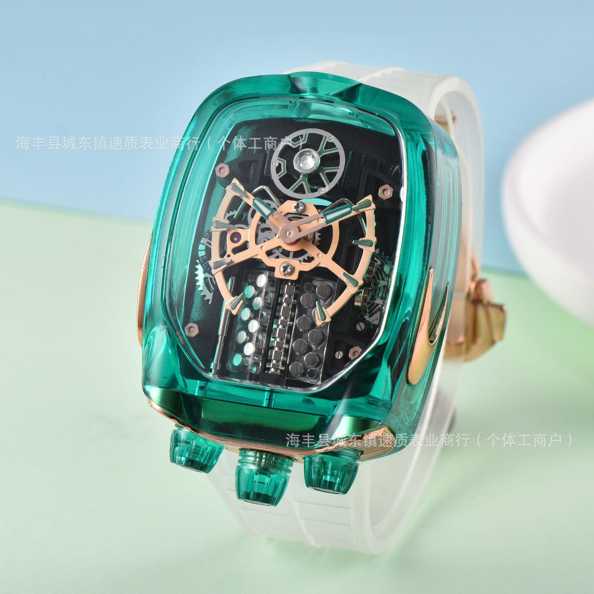 Green mechanical watch with transparent case on a light blue background