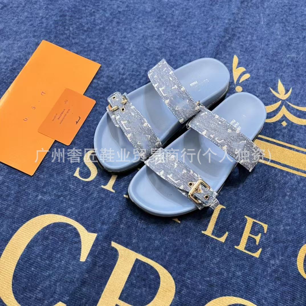 Blue slides with crystal straps on a blue background with gold text