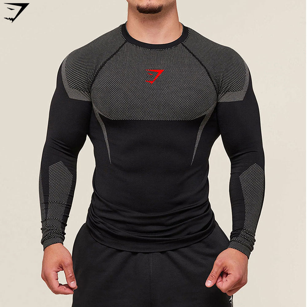 Black athletic long-sleeve shirt with red logo on a beige background