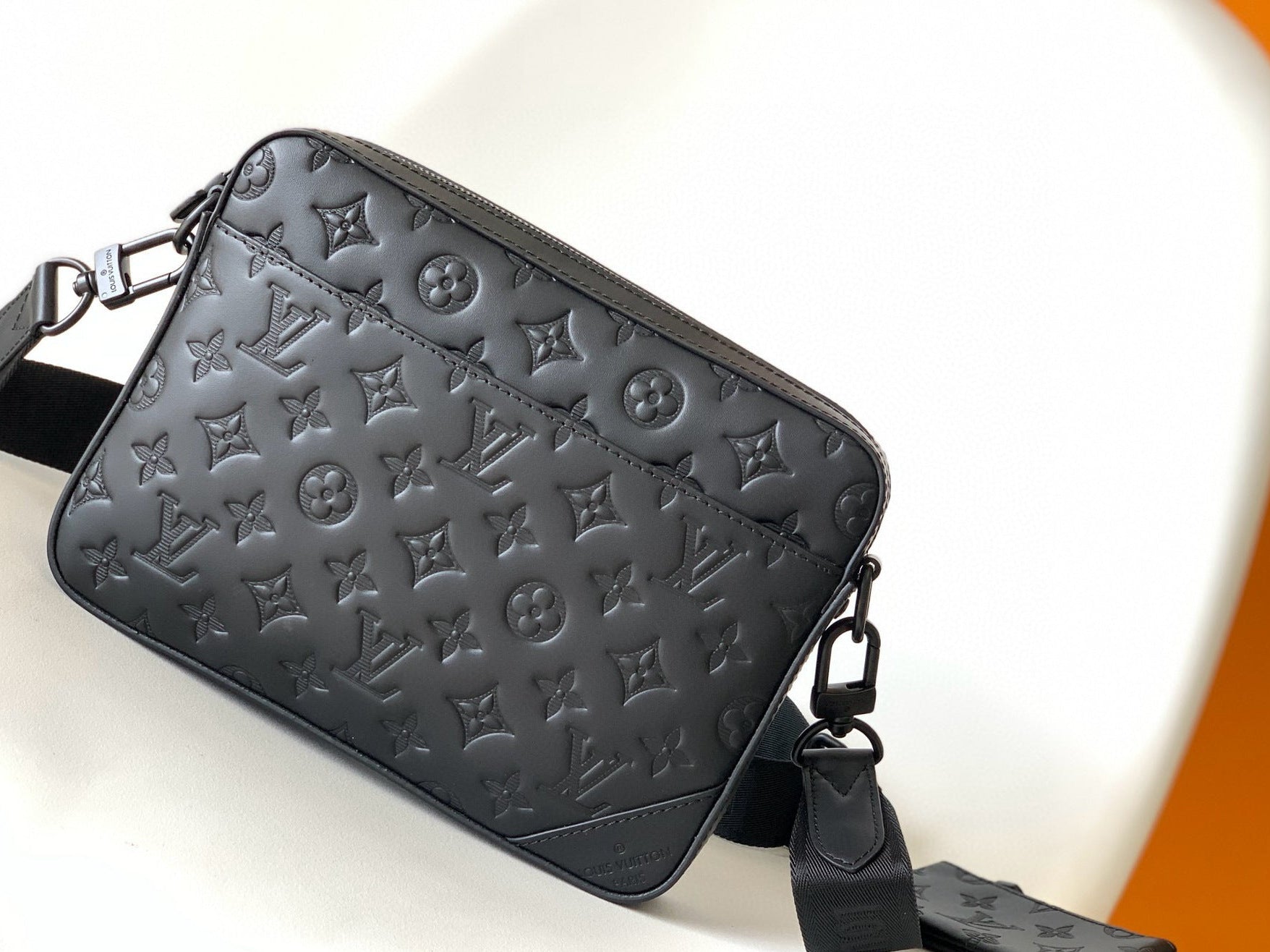 Black leather bag with brand logo on a white background