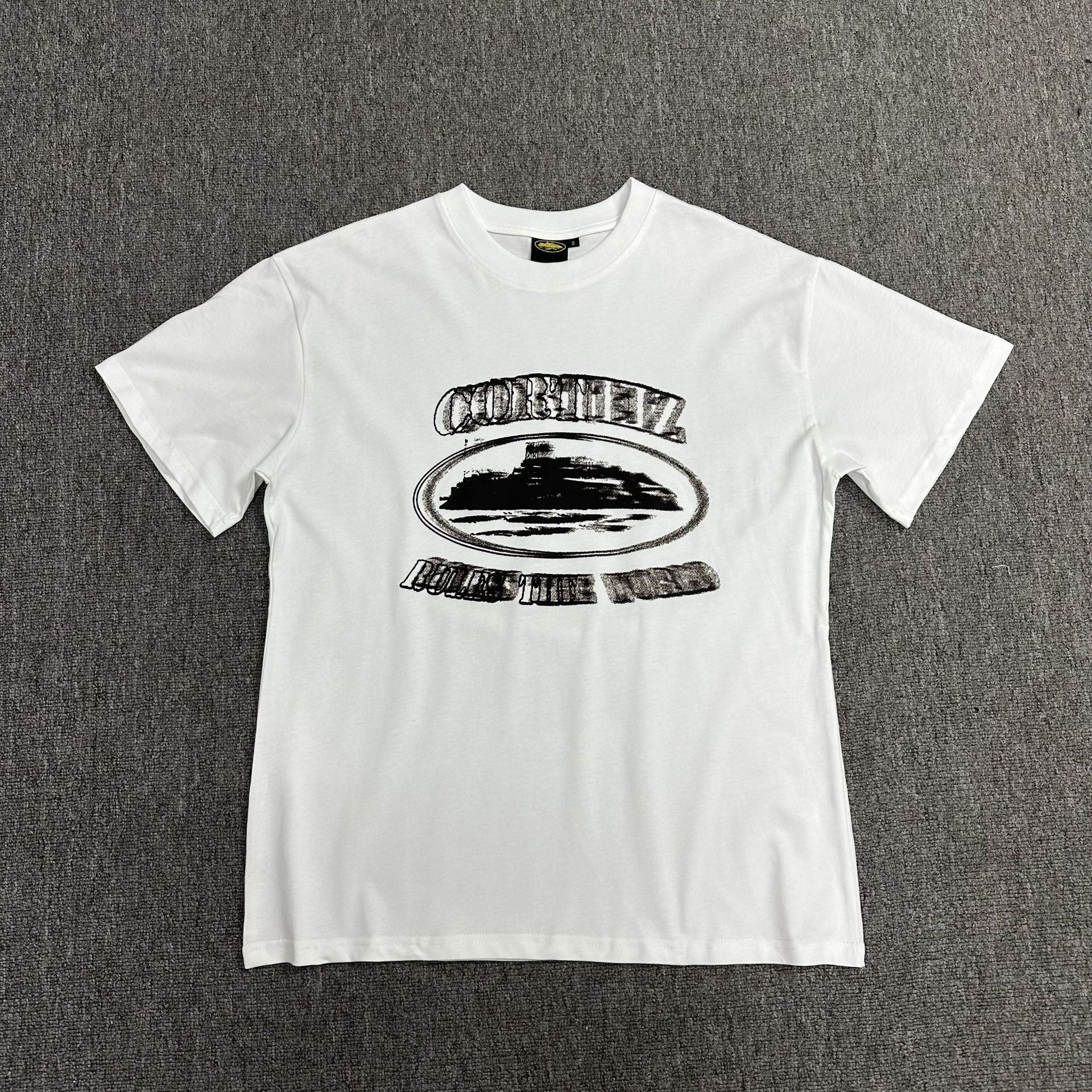 White t-shirt with black graphic design on a gray background