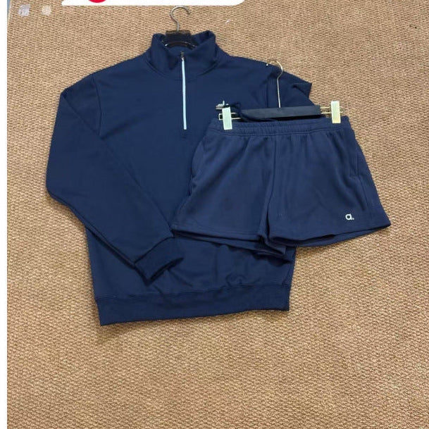 Navy blue tracksuit on a textured brown surface with text overlay