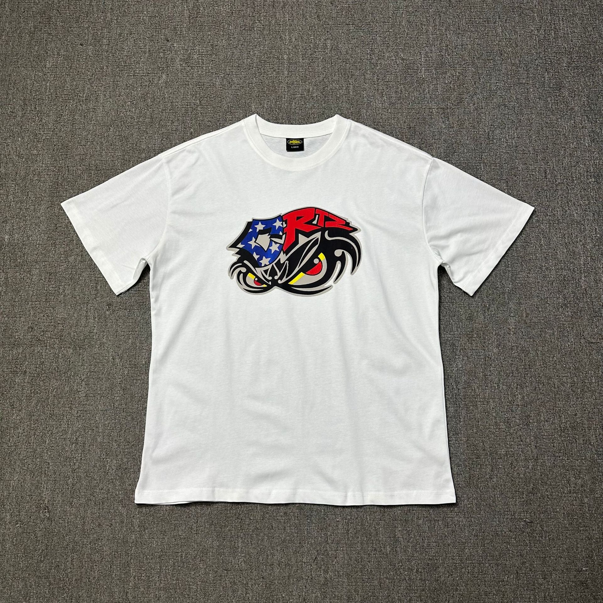 White t-shirt with a colorful graphic on a gray background
