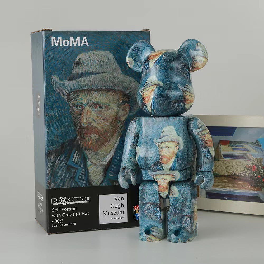 A Bearbrick collectible figure standing in front of its product box. The figure and packaging feature a Van Gogh-inspired painting design with blue tones, a white hat, and small orange and beige painted details.