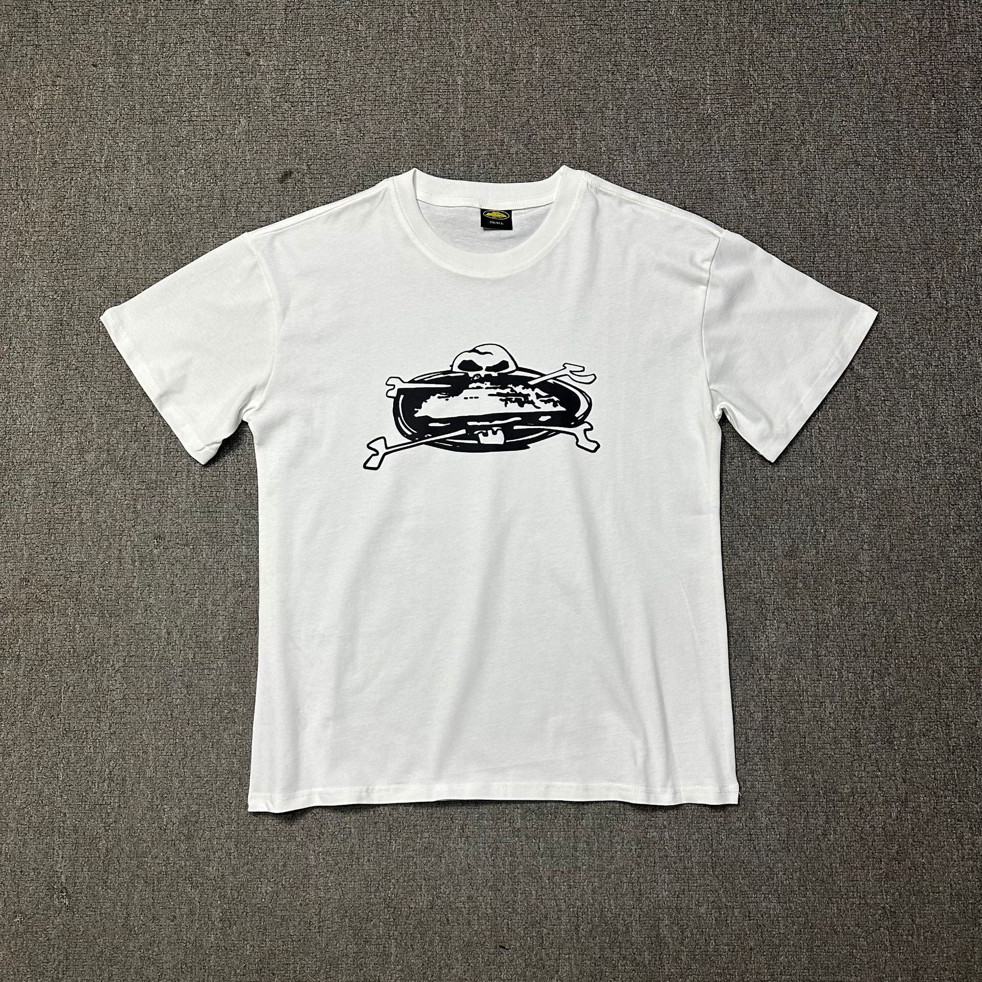 White t-shirt with black graphic design on a gray background