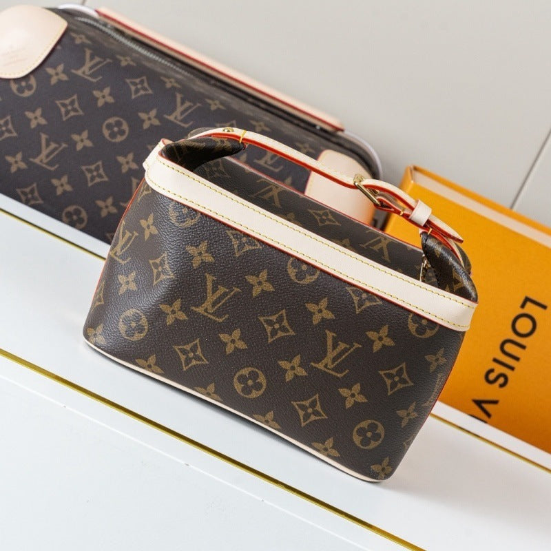 Louis Vuitton monogram canvas cosmetic pouch with cream trim, shown on a white surface next to an orange Louis Vuitton box.