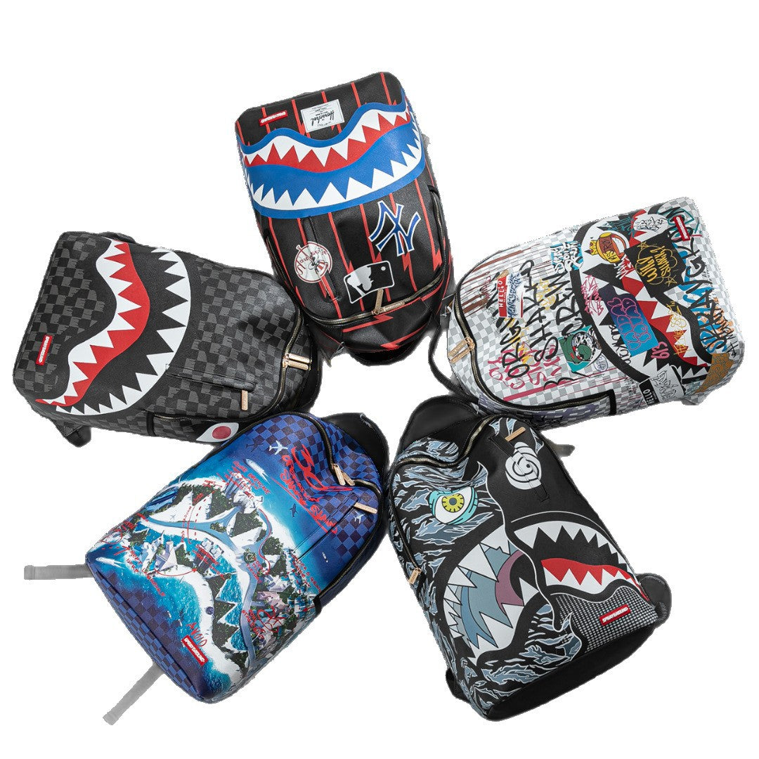 Five graffiti-style shoulder backpacks arranged in a circle on a white background, featuring shark mouth graphics, checkerboard patterns, and colorful urban street art designs.