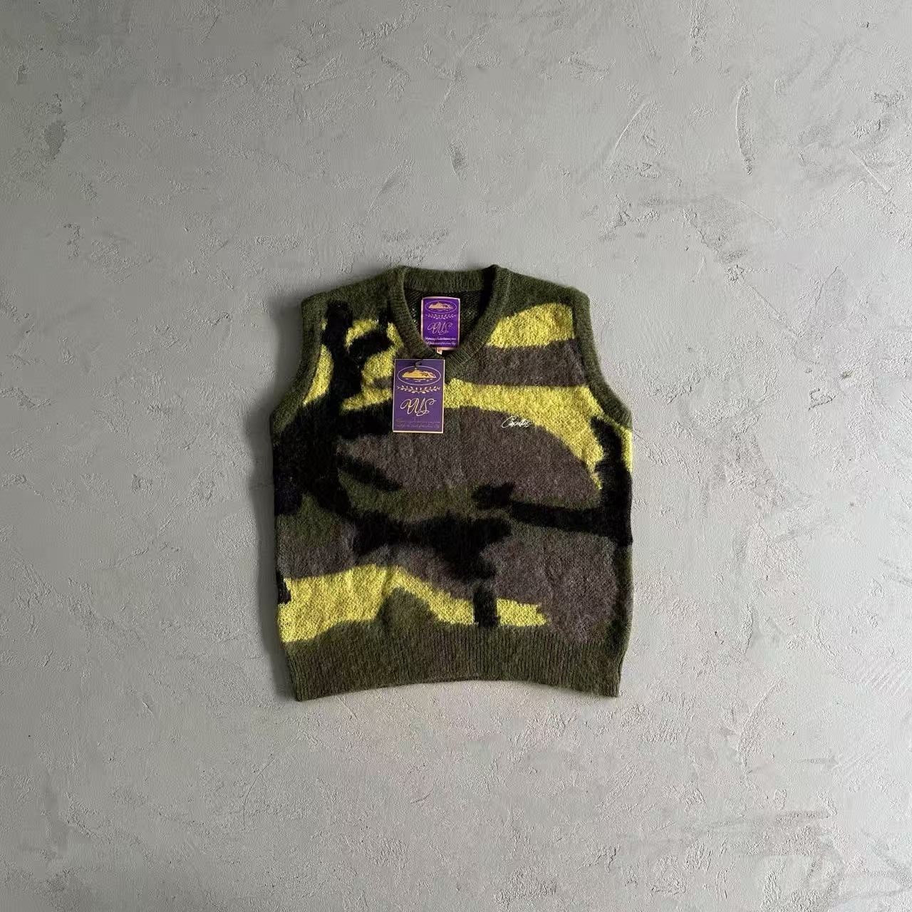 Camouflage-patterned sweater vest on a gray textured background