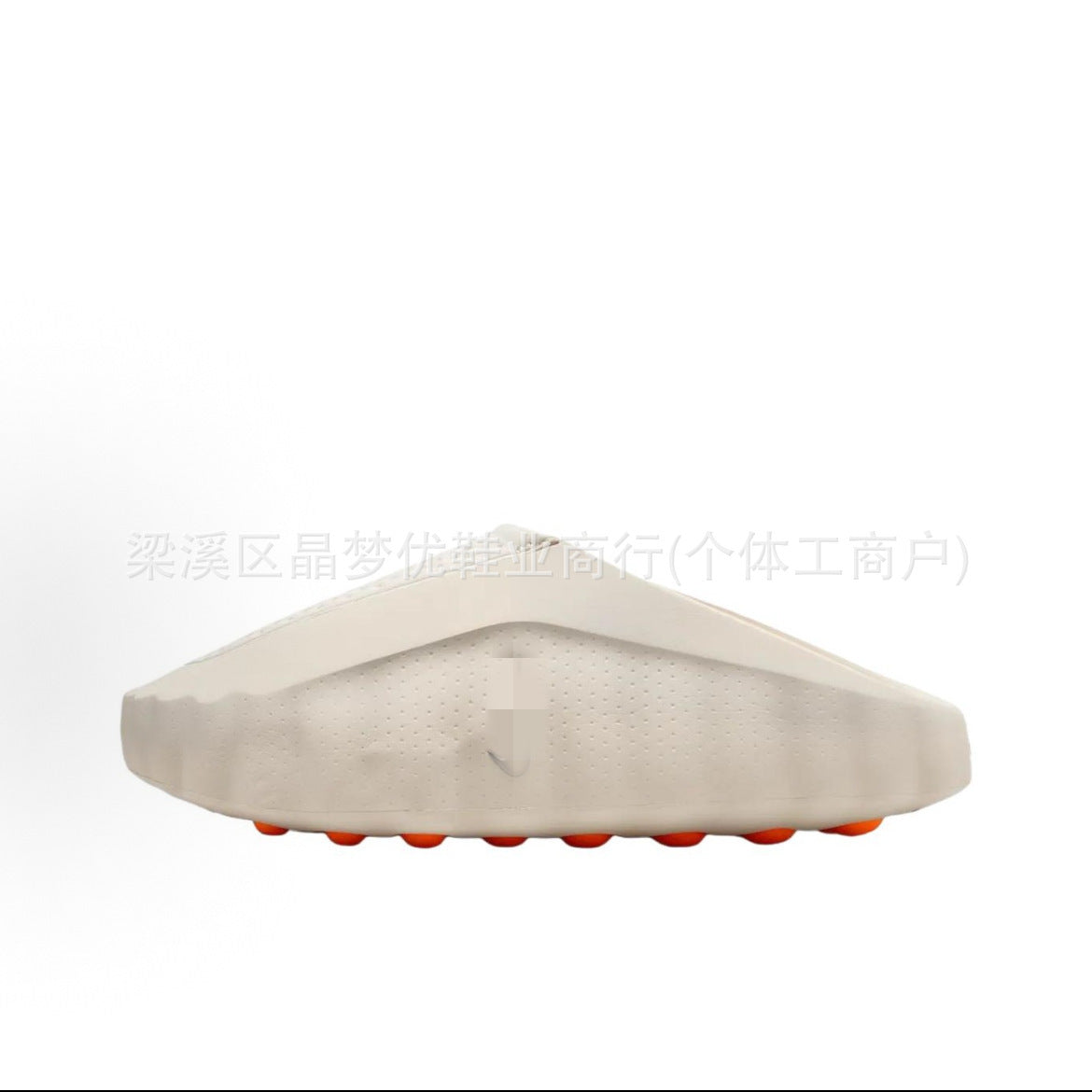 Beige Nike Minds Shoes with orange accents on a white background