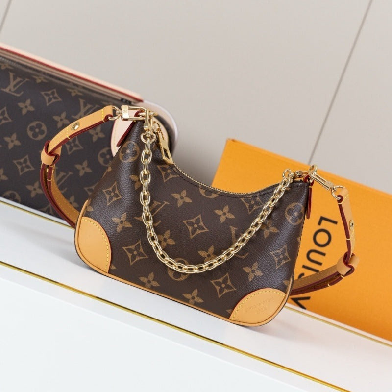 Louis Vuitton monogram canvas shoulder bag with tan leather trim and a gold chain strap, displayed on a white surface with a Louis Vuitton box in the background.