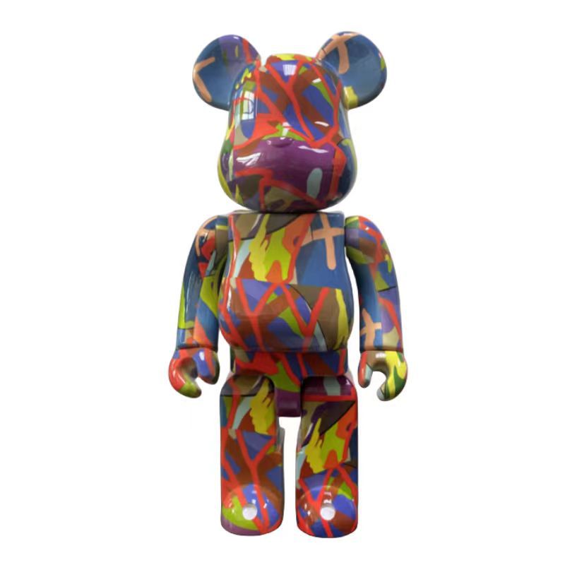 A multicolor graffiti-style bear figure with blue, red, yellow, green, and purple abstract paint splatters, shown against a plain white background.