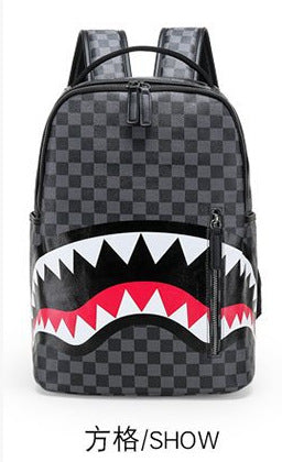 A black and gray checkered shark-mouth backpack with white, red, and black graphic details on the front, shown against a plain white background with Chinese text '方格/SHOW' below.