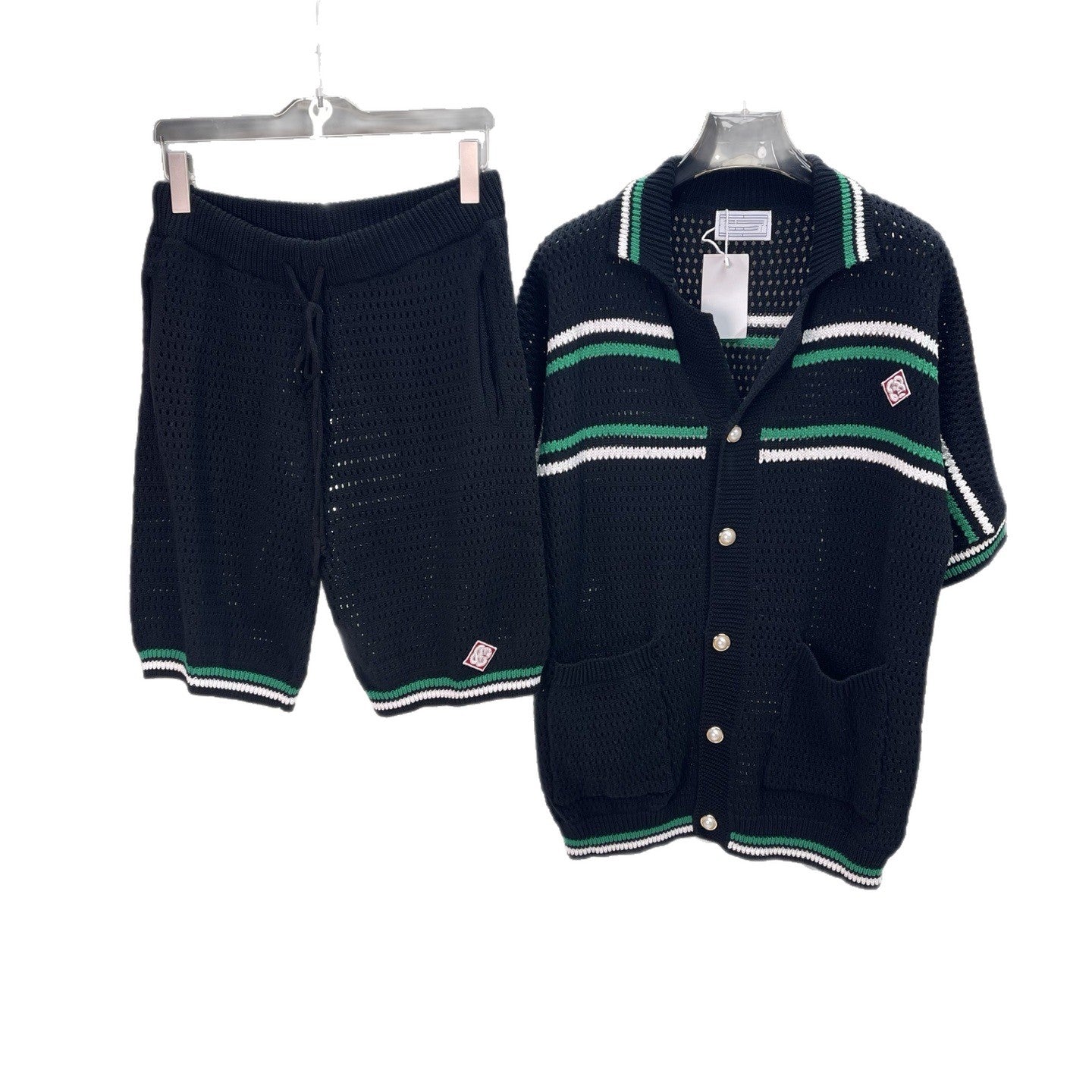 Navy blue cardigan with green and white stripes and matching shorts on hangers against a white background.