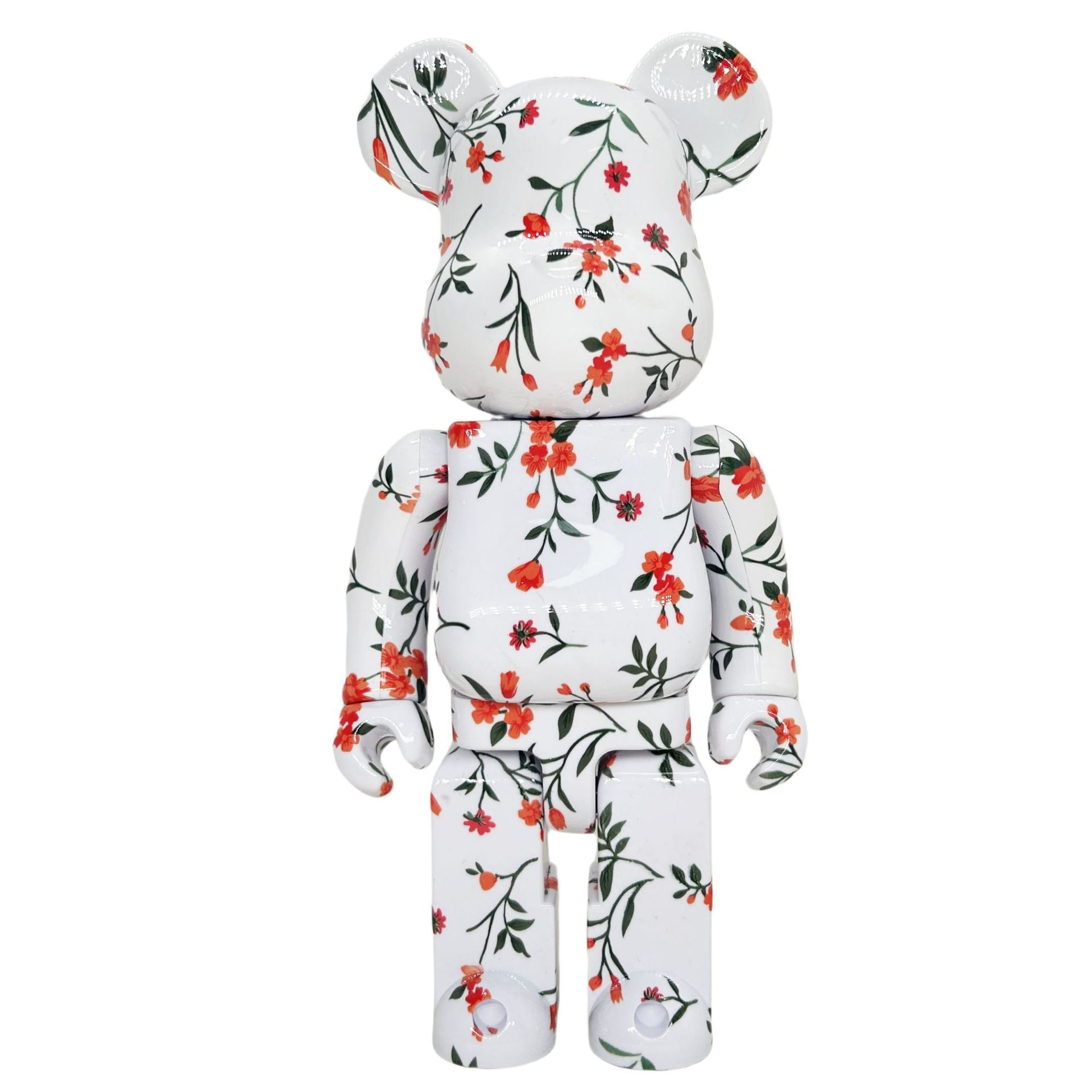 A white bear-shaped collectible figure with a glossy finish, decorated with a red and green floral vine pattern, shown against a plain white background.