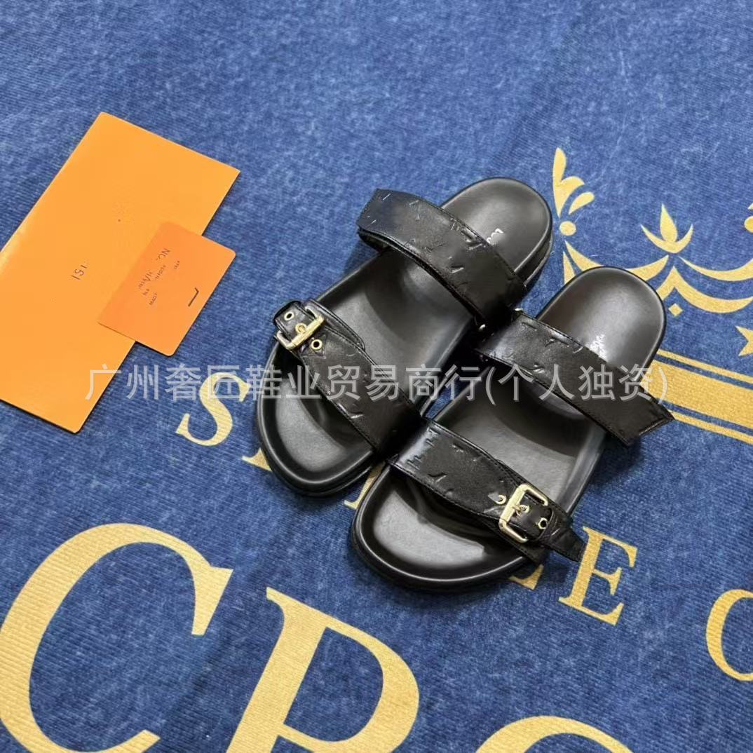 Black sandals on a blue surface with yellow text