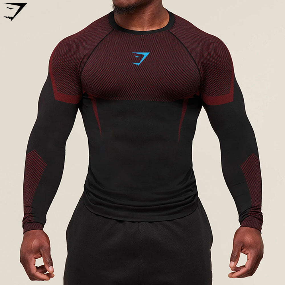 Person wearing a black and red athletic shirt with a logo on a beige background