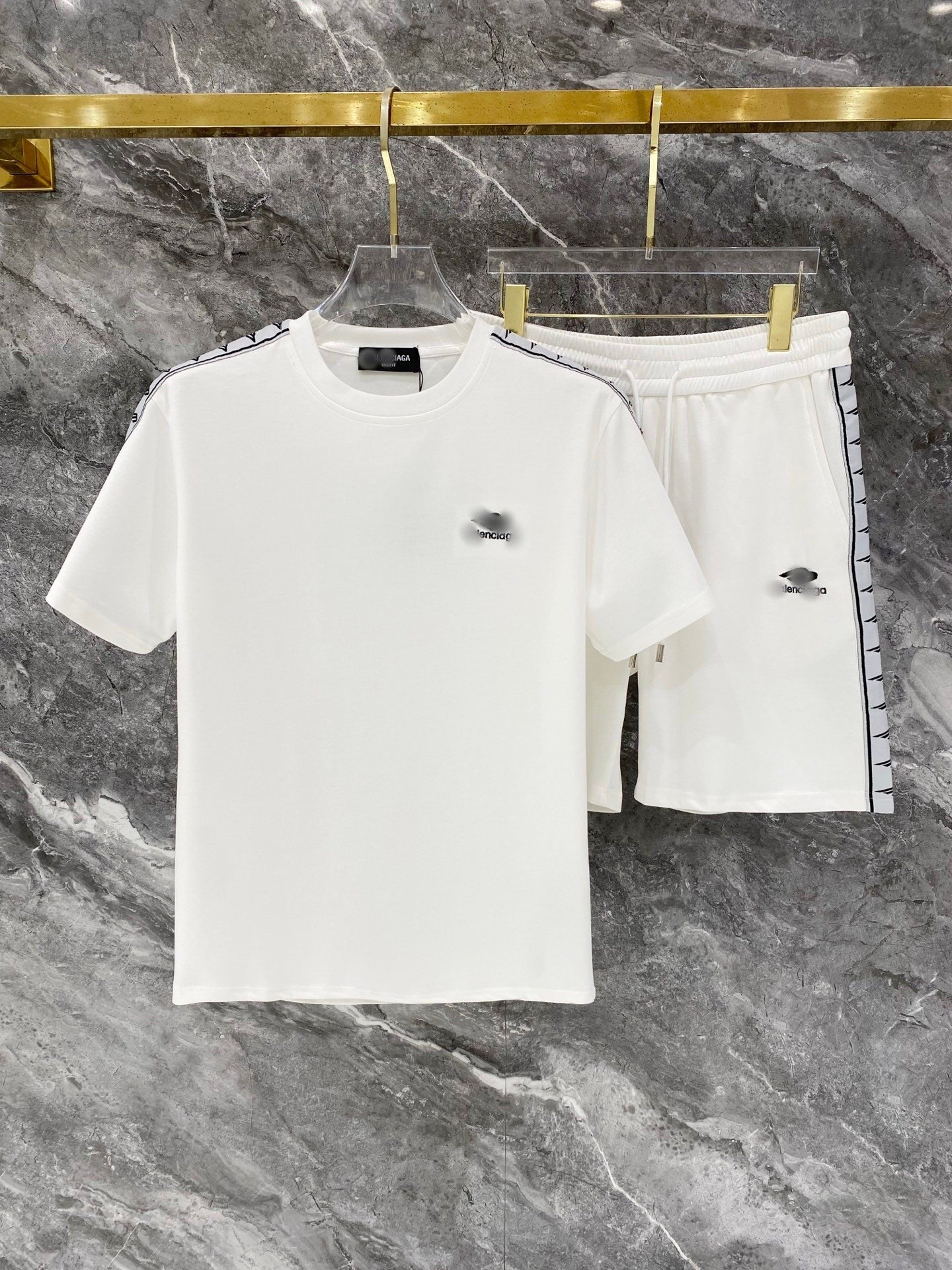White t-shirt and shorts set with brand logo on a marble background