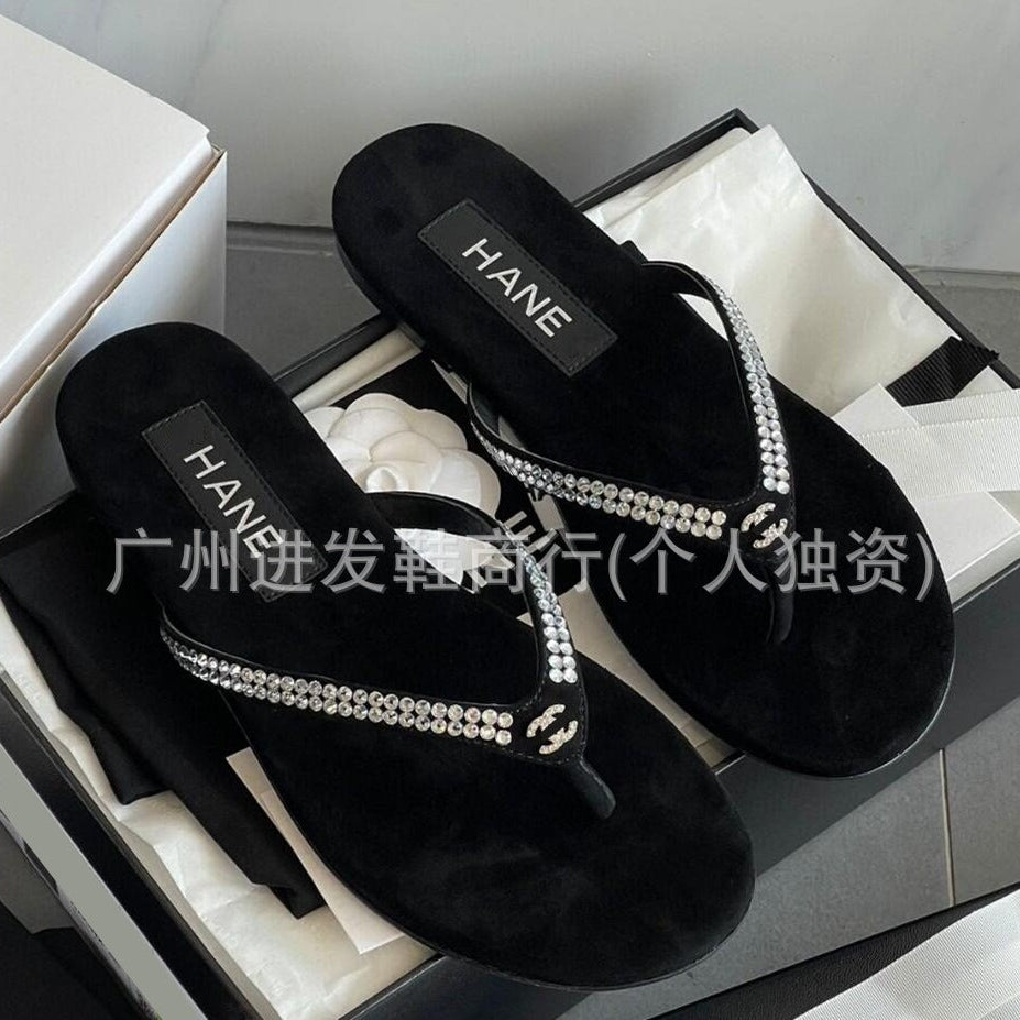 Black sandals with rhinestone straps in a box, featuring the brand 'HANE'.