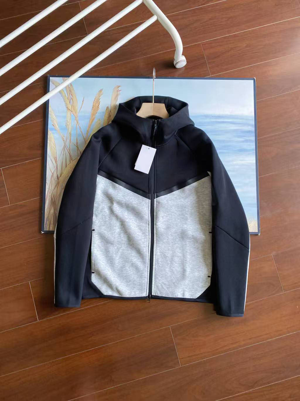Two-tone jacket on a wooden floor with a blurred background