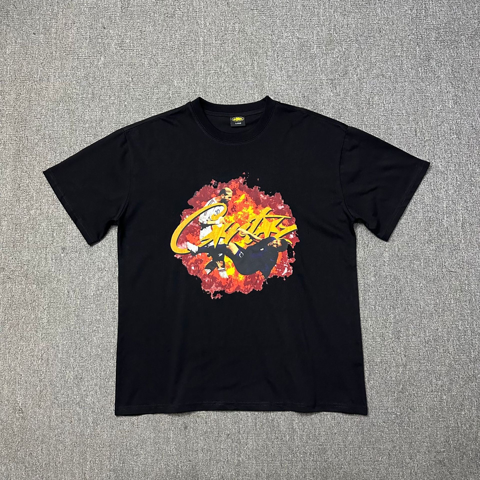 Black t-shirt with colorful graphic design on a gray background