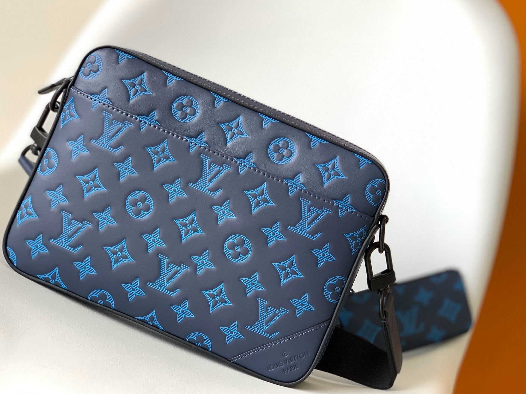Blue patterned handbag on a white background
